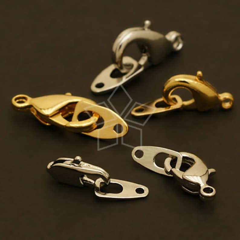 May include: Four different types of metal clasps for jewelry making. The clasps are silver and gold in color. The clasps are all different shapes and sizes.