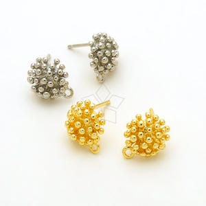 May include: Three pairs of earring findings with a cluster of small balls. The findings are available in gold and silver.