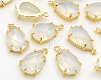 May include: A collection of gold-toned teardrop-shaped pendants with clear opal-like stones. Each pendant has a loop at the top for attaching to jewelry.