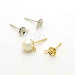 May include: Two pairs of earring findings, one pair is gold and the other is silver. The gold pair has a pearl attached to the finding.