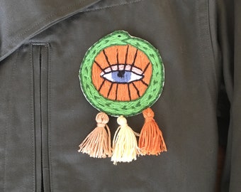 Hand-embroidered round patch with tassels - evil eye and green snake