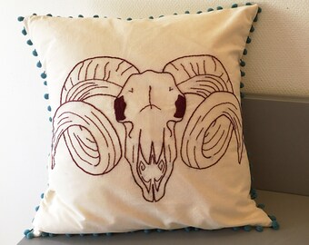 Hand-embroidered decorative pillow cover with ram skull & pom poms