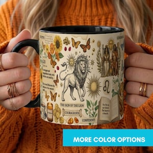 May include: A black ceramic mug featuring a cream-colored wrap-around design with a central lion illustration, sunflowers, butterflies, and celestial motifs. Text includes 'LEO', 'THE SIGN OF THE LION', 'COURAGEOUS', 'CONFIDENT', and 'GENEROUS' alongside an open book.