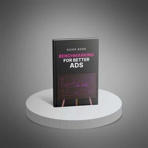 May include: A black guidebook titled "Benchmarking for Better Ads" stands on a white pedestal. The book's cover features the title in pink and white text, with a graphic of a chart. The book is a guide for advertising.