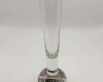 May include: A clear glass vase with a round, bubbled base and a tall, slender neck.