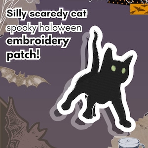 May include: An embroidered patch featuring a black cat with arched back and glowing green eyes. The text reads: Silly scaredy cat spooky haloween embroidery patch! The design includes illustrations of bats, spiderwebs, and a coffee mug.