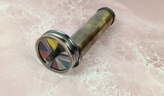 A hand-engraved brass kaleidoscope with floral steampunk detailing — a genuinely beautiful optical instrument that feels like it belongs in a Victorian curiosity cabinet.