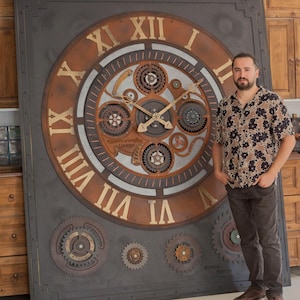 May include: A large, square wall clock with a steampunk design. The clock face features Roman numerals, gears, and a bronze and gray color scheme. The clock is approximately 6 feet tall.