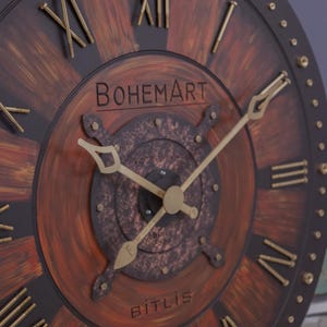 May include: Large, round wall clock with a rustic, industrial design. The clock face features a dark brown background with radial brushstrokes of lighter brown. Gold-colored Roman numerals and hands are used. The clock has the text "BOHEMART" and "BITLIS".