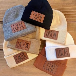 May include: A set of three ceramic mugs with a speckled, matte finish. The mugs are in shades of cream, light gray, and dark gray. Each mug has a simple, minimalist design, perfect for coffee or tea.