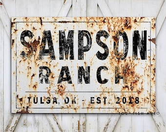May include: A rusty metal sign with black lettering that reads "Sampson Ranch Tulsa, OK - Est. 2018".