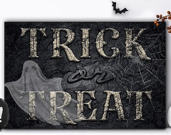 May include: A rectangular wall sign featuring the text TRICK or TREAT in distressed gold lettering against a dark, textured black background. A translucent white ghost and a spider web are visible behind the text on the sign.
