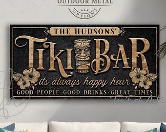 May include: A black and gold Tiki Bar sign with the text "The Hudsons' Tiki Bar" and the phrase "It's always happy hour. Good people. Good drinks. Great times."