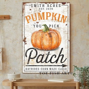 May include: A vintage-style sign with a distressed white background and black text. The sign reads "Smith Acres Est. 2020 Pumpkin You Pick Patch Hayrides Corn Maze Cider Toe Fish Art". A large orange pumpkin is featured in the center of the sign.
