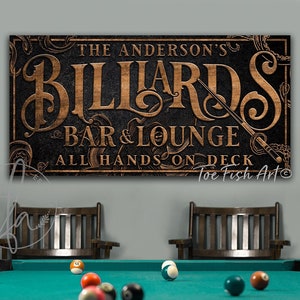 May include: A black and brown wooden sign with the text "The Anderson's Billiards Bar & Lounge All Hands On Deck Toe Fish Art" in a vintage style font.
