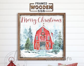 May include: A framed wooden sign with the text "Merry Christmas" in white lettering. The sign features a red barn with white trim and a red door. The barn is surrounded by snow-covered trees and a snowy landscape.