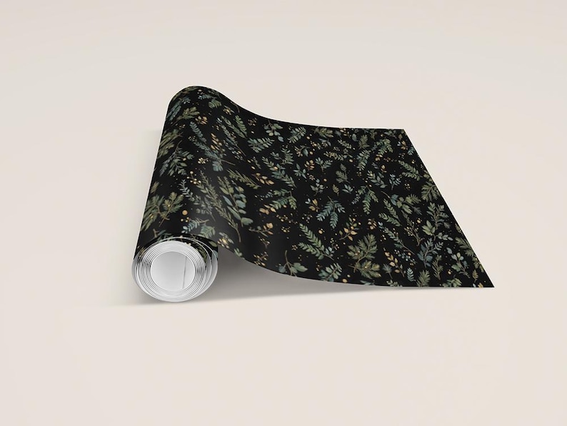 May include: A roll of black wallpaper with a botanical pattern. The design features green and gold-colored leaves and small floral accents. The wallpaper is unrolled, revealing the pattern.