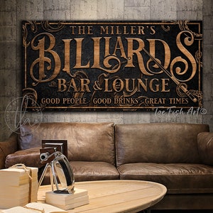 May include: A vintage-style sign with a dark background and gold lettering that reads "The Miller's Billiards Bar & Lounge. Good People. Good Drinks. Great Times." The sign has a decorative border and a sword design.