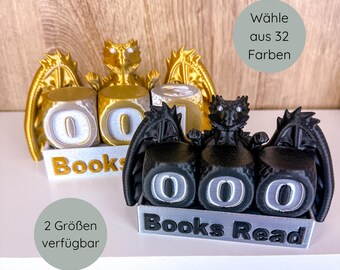 May include: Dragon-themed bookends in gold and black. The bookends feature a dragon figure with wings and three rotating number blocks to track books read. The base reads "Books Read". The image also includes text that says "Choose from 32 colors" and "2 sizes available."