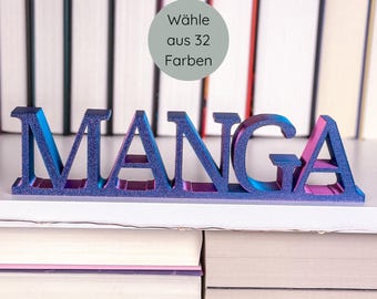 May include: A glittery blue and purple "MANGA" sign, displayed on a white shelf in front of a stack of books. The sign has a gradient effect, transitioning from blue to purple. A circular graphic above the sign reads "Wähle aus 32 Farben".