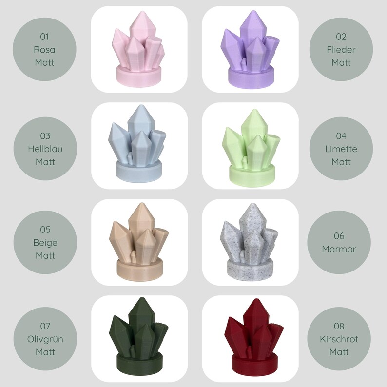 May include: Eight crystal-shaped decorative objects in shades of pink, lilac, pale blue, lime green, beige, grey, dark green, and deep red. Each crystal is displayed with a colour label and the word "Matt" on a white background.