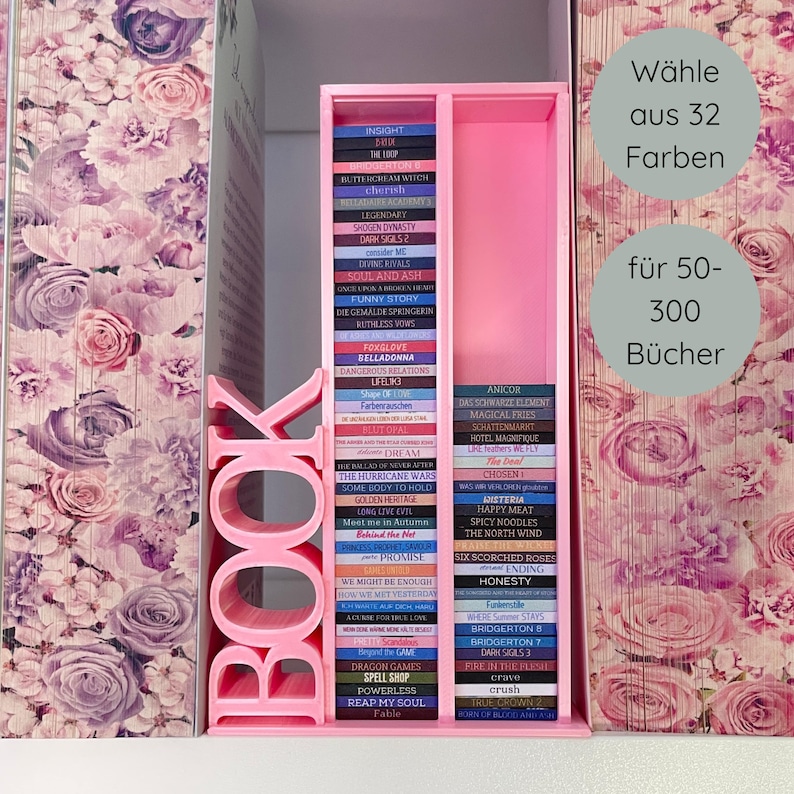 May include: A pink bookshelf with the word "BOOK" cut out of the side, holding a collection of colorful books. The books are arranged in two columns, with titles visible. The background features floral wallpaper and text that says "Choose from 32 colors for 50-300 books."