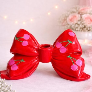 May include: A set of three ceramic mugs with a speckled, matte finish. The mugs are in shades of cream, light gray, and dark gray. Each mug has a simple, minimalist design, perfect for coffee or tea.