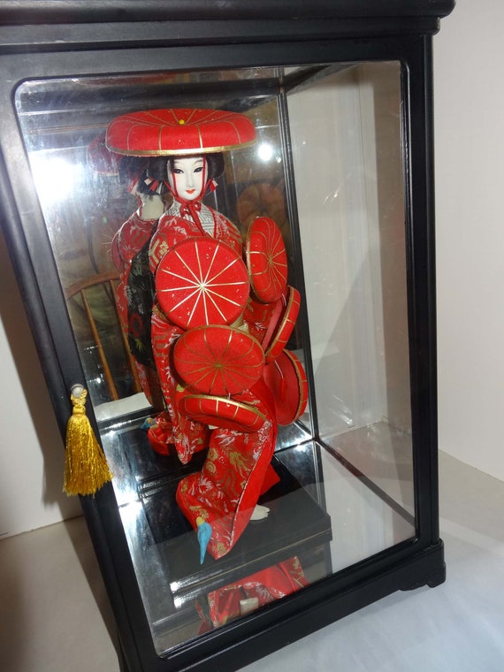 japanese doll in glass case