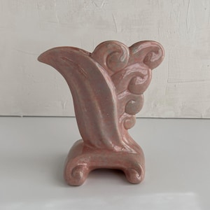 May include: A set of three ceramic mugs with a speckled, matte finish. The mugs are in shades of cream, light gray, and dark gray. Each mug has a simple, minimalist design and a rounded handle. The mugs are stacked on top of each other.