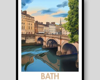May include: A framed art print depicting the Pulteney Bridge in Bath, England, featuring stone arches over a river, historic buildings, and a large green tree under a soft sunset sky. The text BATH ENGLAND is printed in beige at the bottom.