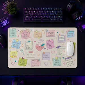 May include: A rectangular desk mat featuring a cream-colored background with various pastel-colored sticky notes, checklists, and motivational text such as 'You Got This', 'Focus on the Good', and 'Progress, Not Perfection' alongside small hand-drawn doodles.