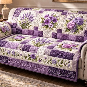 May include: A quilted sofa cover featuring a patchwork design with lavender and floral patterns in shades of purple, white, and green. The cover is draped over a beige sofa, enhancing the room's decor.