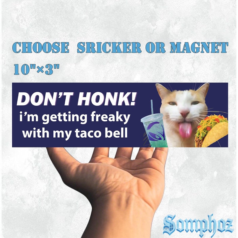 May include: A rectangular sticker or magnet with the text "DON'T HONK! i'm getting freaky with my taco bell." The image features a cat with its tongue out, a Taco Bell drink, and a taco. The sticker measures 10" x 3".