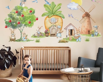 May include: A nursery wall decal set featuring a whimsical scene with bunnies, a windmill, a carrot house, and a tree with apples. The decals are in a watercolour style with soft colours and are perfect for a child's room.