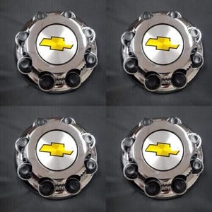 May include: Set of four chrome wheel covers with a silver center and a yellow Chevrolet logo.
