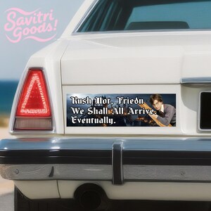 May include: A white car's rear with a bumper sticker that reads "Rush Not, Friend - We Shall All Arrive Eventually." The sticker features an image of a person and a castle. The Savitri Goods! logo is in the upper left corner.