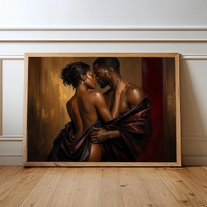 May include: A framed horizontal wall art print depicting a couple in an intimate embrace. The figures are draped in dark, flowing fabric against a warm, golden-brown and deep red background, highlighting their skin tones and close connection.