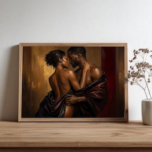 May include: A framed wall art print depicting a couple in an intimate embrace, draped in dark fabric against a warm, golden-brown background. The artwork features rich tones of deep red and bronze, capturing a moment of connection between two figures.