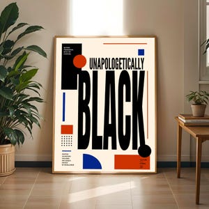 May include: A rectangular wall art print featuring the bold black text UNAPOLOGETICALLY BLACK on a cream background. The design includes geometric shapes in red and blue, including circles, rectangles, and a grid of dots, with small black text blocks.