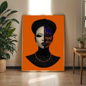 May include: A framed wall art print featuring a stylised portrait of a person wearing a black headwrap and a multi-coloured beaded necklace. The face is split, with one side white with dark speckles and the other side black with orange and blue patterns.