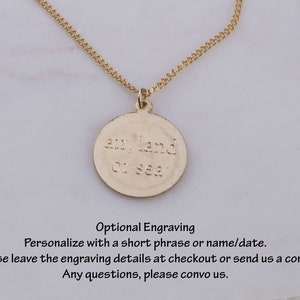 May include: Gold necklace with a round pendant that says "air, land or sea".