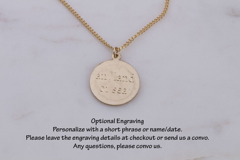 May include: Gold necklace with a round pendant that says "air, land or sea".