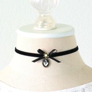 Black velvet choker necklace with satin bow and floral pendant