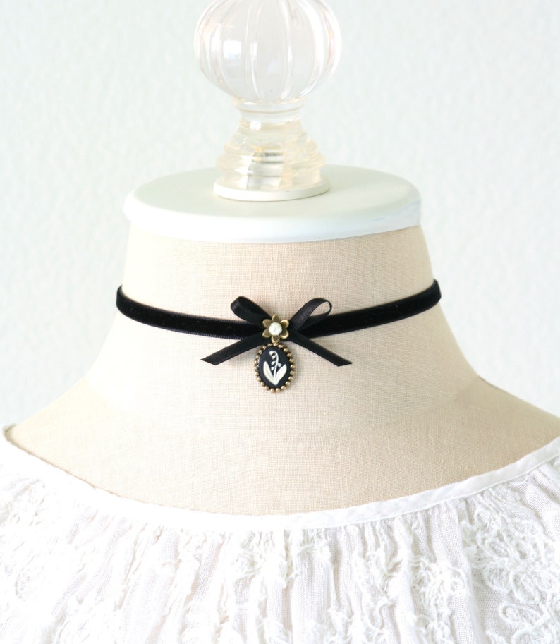 Black velvet choker necklace with satin bow and floral pendant