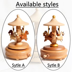 May include: Wooden carousel music boxes, available in two styles, A and B. Each features a rotating platform with wooden horses in various colors, topped with a light-colored canopy. The text "Available styles" and style names are visible.