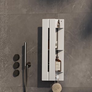 May include: A white, wall-mounted shower shelf with three compartments. The shelf holds various brown bottles and a small bottle. A round, natural-bristle brush hangs from the bottom. The shelf is mounted on a gray tiled wall.