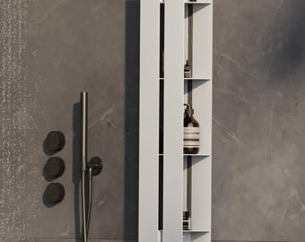 May include: A vertical white wall-mounted shower organizer with multiple open shelves holding various toiletries, including a brown pump bottle and small tubes. A circular beige textured sponge hangs from a hook at the bottom of the unit.
