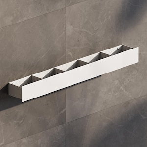 May include: A white, rectangular wall-mounted shelf with six compartments. The shelf is made of a solid material and is mounted on a gray tiled wall. The compartments are divided by vertical dividers, creating individual storage spaces.