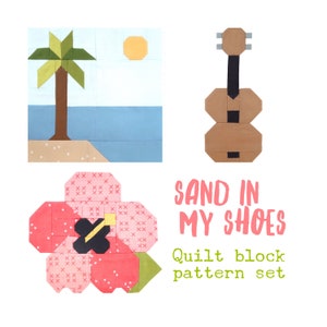 Op de afbeelding: Een quiltblokpatroonset genaamd "Sand in My Shoes". De set bevat een palmboom op een eiland, een gitaar en een roze hibiscusbloem.