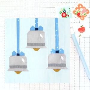 May include: Three gray bells with blue ribbons hanging from blue and white patterned strings on a light blue background.
